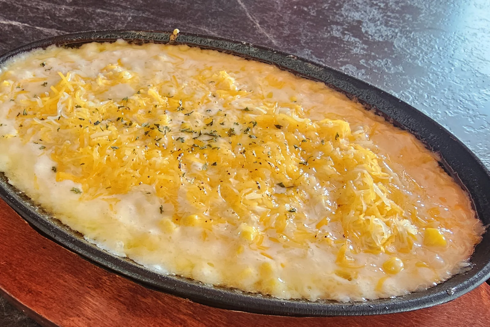 Corn cheese served on a hot cast-iron plate