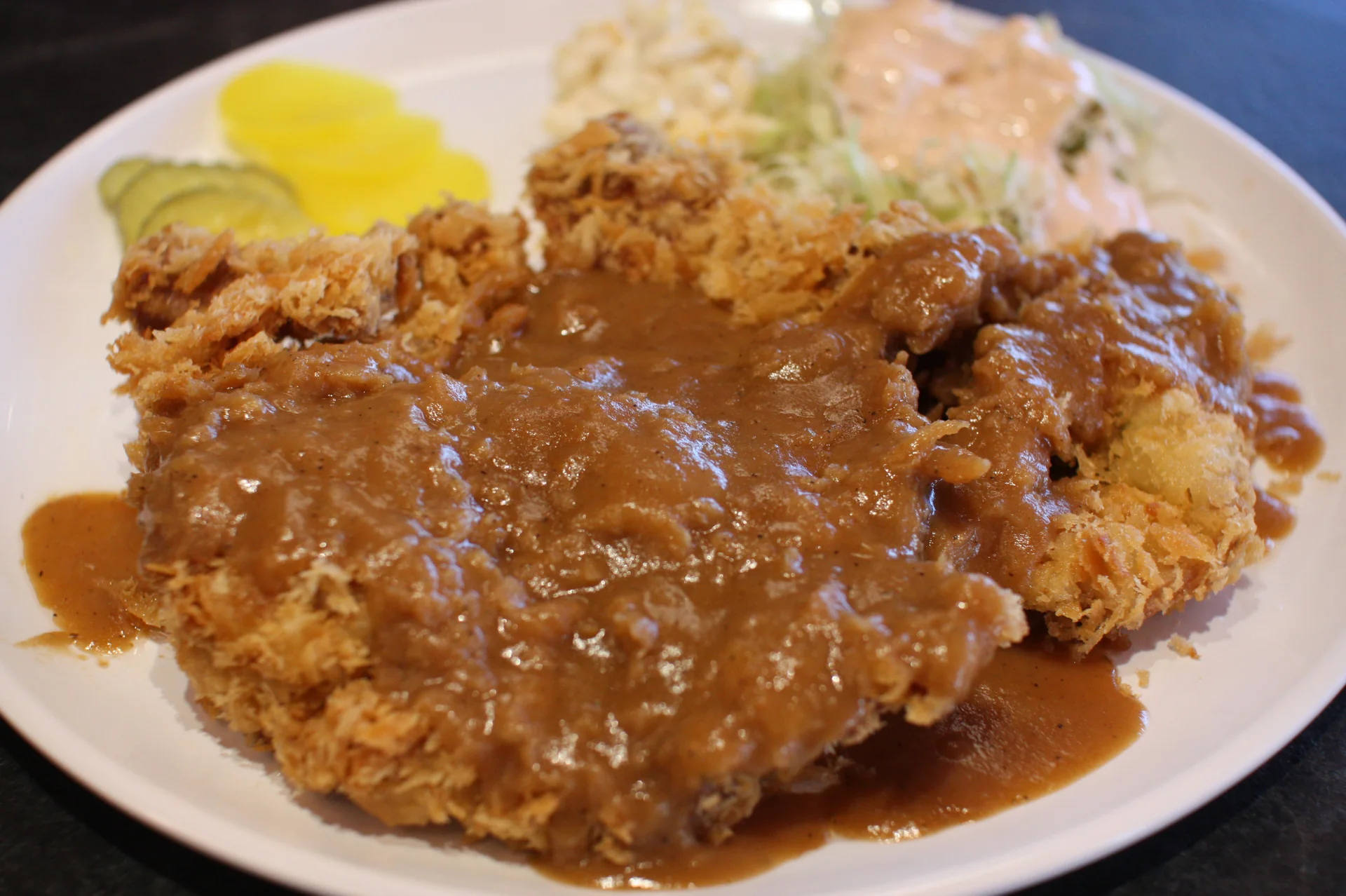 King Katsu Land’s wide, thin Korean wang donkatsu with brown sauce, macaroni salad and pickled radish