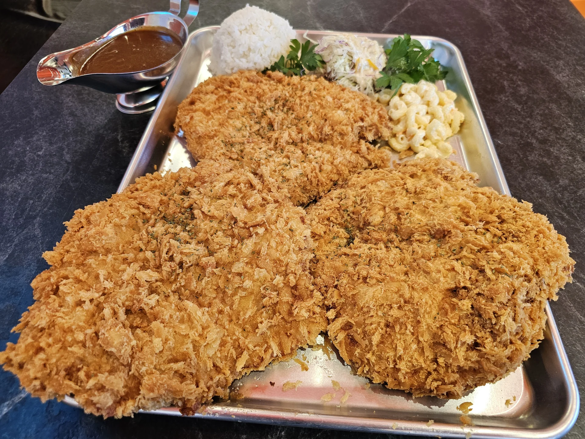 The Legendary Challenger: large Korean king katsu on a tray with rice, salad and sauce